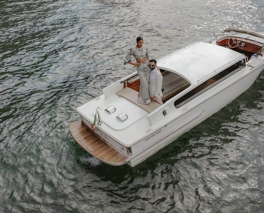 A couple on the deck of a wooden boat seen from above